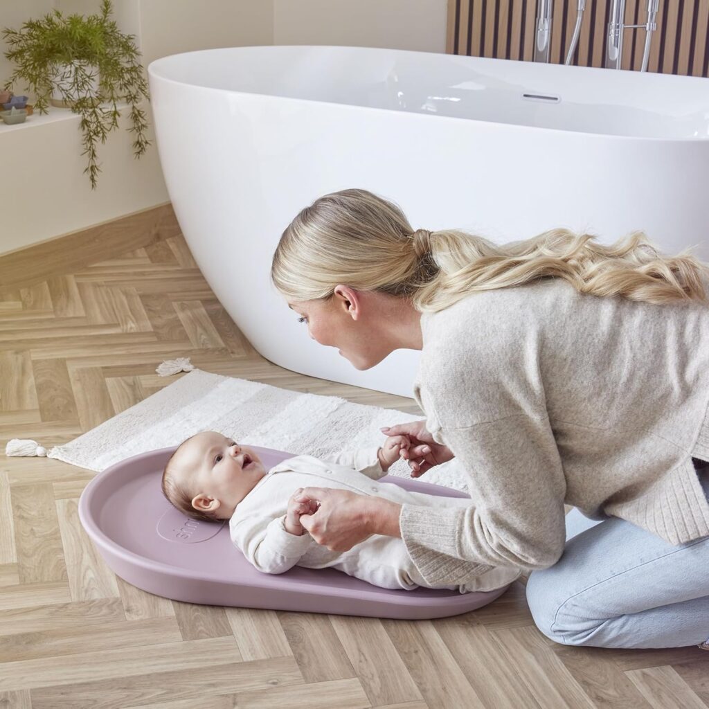 Ergonomic wedge changing mat with raised sides for secure diaper change and anti-roll safety support.