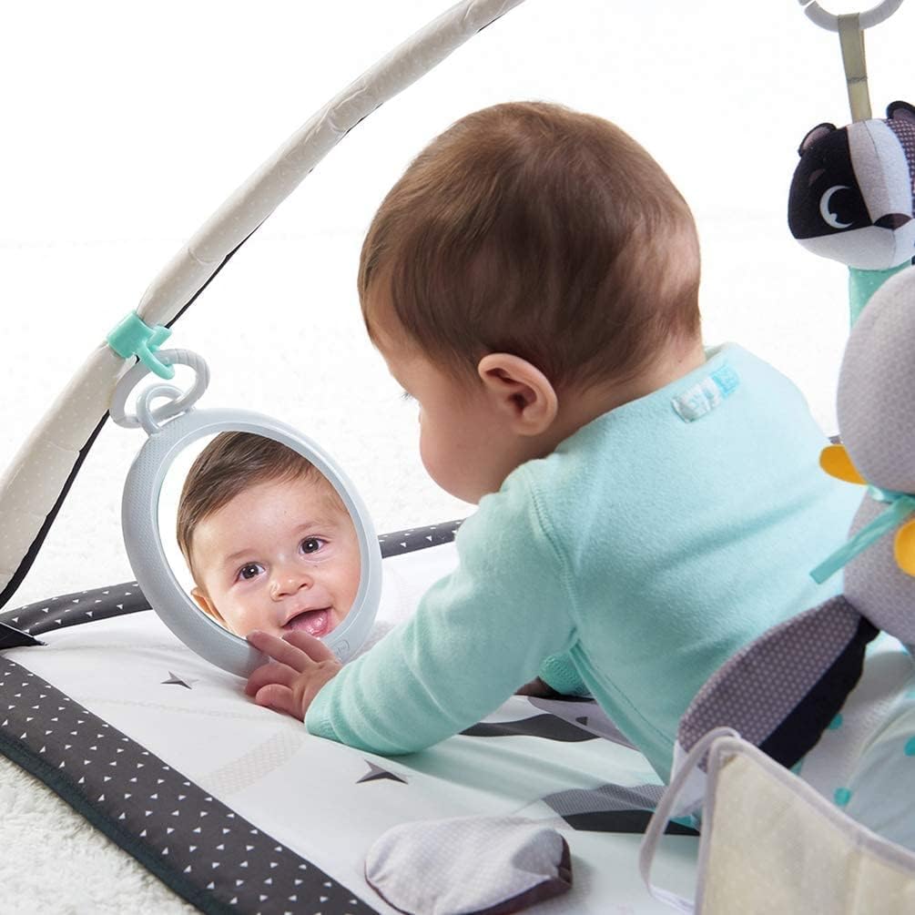Baby engaging in tummy time on a Tiny Love Black & White Gymini activity mat with high-contrast toys.